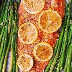 salmon, asparagus and lemons on a tray