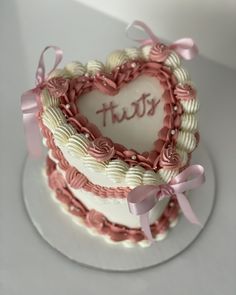 a heart shaped cake with the word trust written on it