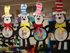 the bulletin board is decorated with paper hats and teddy bears