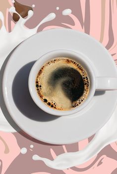 a cup of coffee on a saucer with milk splashing around the top and bottom