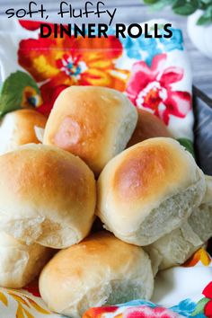 soft, fluffy dinner rolls on a floral plate with the title in the middle above it