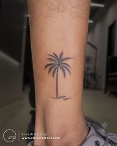 a small palm tree tattoo on the ankle