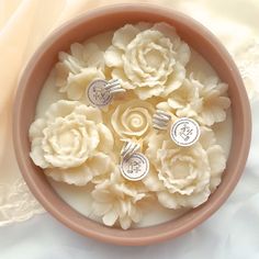 a bowl filled with white flowers on top of a table