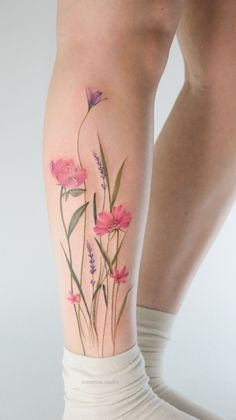 a woman's leg with flowers on it