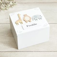 a white box that has some wooden animals on it and the words freckle