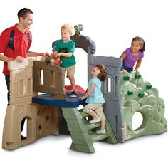 two adults and three children playing in a play set