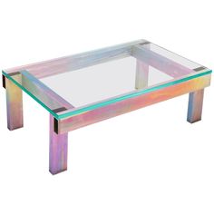 a coffee table with a glass top and multicolored metal legs, on a white background