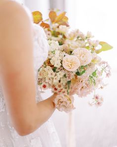 a bride holding a bouquet of flowers in her hand