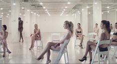 a group of women sitting in white chairs