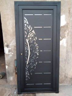 a black door with an intricate design on it