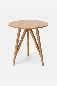 a round wooden table with two crossed legs