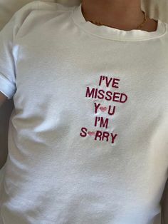 a woman wearing a t - shirt that says i've missed you i'm sorry