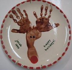 a plate with handprints on it that says happy holidays