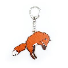 a keychain with an image of a red fox on it's side