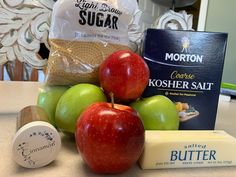 apples, cheese and butter are sitting on a counter top next to an assortment of ingredients