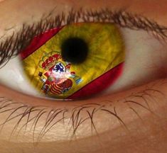 the flag of spain is reflected in an eye