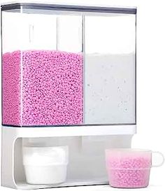 a pink and white cabinet with two cups on it's sides, next to a cup holder