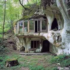 an unusual house built into the side of a tree