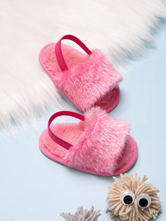 a pair of pink slippers sitting next to a stuffed animal