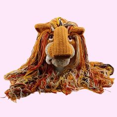 an animal made out of yarn with long hair on it's face and nose