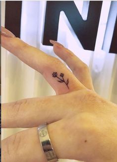 two people with matching tattoos on their fingers