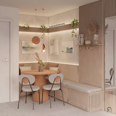 a dining room with two chairs and a round table in the center, surrounded by plants