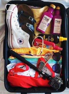 an open suitcase filled with clothing and other items