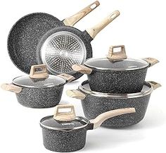 an assortment of granite pots and pans with wooden handles are shown in this image