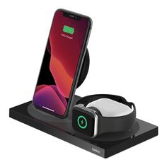 an iphone and headphone charging station on top of a charger with the dock attached to it