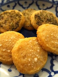 some food is on a plate with blue and white designs around it, including three cookies