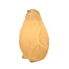 a yellow bear shaped light on a white background