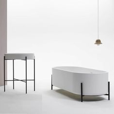 a white bath tub sitting next to a table