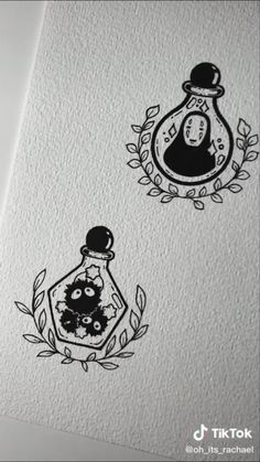 two black and white ink drawings of bottles with flowers in the bottom, one is empty