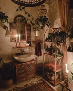 a bathroom with plants and candles on the wall