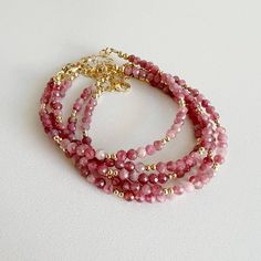 Genuine faceted pink tourmaline & high quality 14k gold filled beads & findings; adjustable. Size: 6” + 1.5” gold filled extender Lobster clasp 4mm pink tourmaline 3mm 14k gold filled beads Each natural stone is unique and therefore no two are alike. Pearls, stones, colors and sizes may vary. High quality 14/20 14k gold filled beads & findings, made in the USA. Beads & findings will not turn, tarnish, or rust. Handmade with the highest standards & quality materials. Includes 100% organic cotton Pink Stone Bracelet, Faceted Beads Bracelet, Pink Tourmaline Bracelet, Pink Handmade Jewelry, Pulseras Aesthetic, Beauty House, Pink Beaded Bracelets, Cotton Jewelry, Tourmaline Bracelet