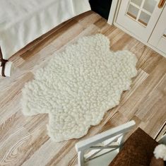 a white rug is on the floor next to a door