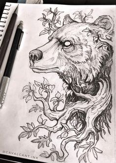 a drawing of a bear with leaves on it's head and eyes, next to a pen