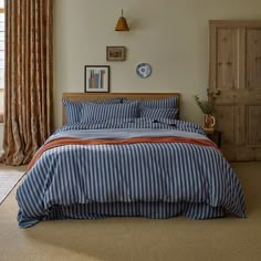 a bed sitting in a bedroom next to a window