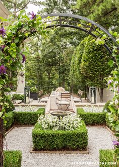 an outdoor dining area is surrounded by greenery