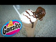 an ice cream sundae with chocolate on top and gansito candy bar in the background