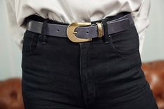 This classic leather belt for jeans & dresses features a bold buckle in matte gold that provides just the right amount of styling flair for your everyday & evening looks. It's matching gold keeper provides a vintage appeal that really ties together this classic leather belt for women. Amsterdam Heritage is a leader in vintage leather belts providing a variety of colors & widths for your heart's desire. This slim jeans' belt fits perfectly through most pants loops & can be cross purposed around y Business Gold Belt With Brass Buckle, Chic Formal Belt With Brass Buckle, Chic Formal Belts With Brass Buckle, Gold Belt Buckles For Work, Trendy Belt With Gold Buckle For Work, Modern Gold Belt Buckles For Business, Trendy Formal Belt With Gold Buckle, Trendy Gold Leather Belt Buckles, Gold Belt With Brass Buckle For Work