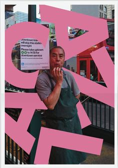 a man standing in front of a pink sign with the letter q on it's side