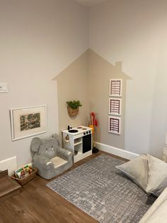 a child's room with an elephant chair and play area in the corner,