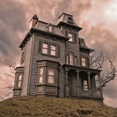 an old house sitting on top of a hill