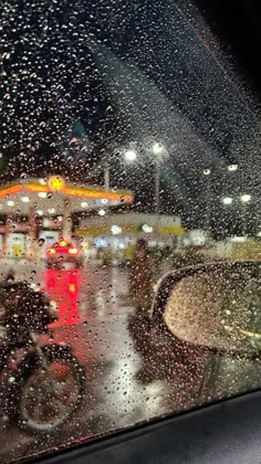 rain is falling on the windshield of a car