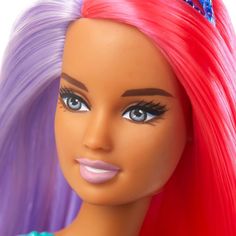 a close up of a barbie doll with pink hair and blue eyes wearing a tiara