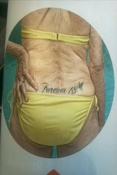 an old woman's stomach with tattoos on it