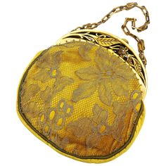 A charming and highly decorative handbag, made from golden/amber silk velvet, which has a veil, or netting, layer over the top , giving a delicacy and depth to the handbag. Topped with a beautiful carved and hand coloured Bakelite frame, the handle is made from celluloid, typical of many of the designs of this period. On opening a lovely yellowy green lining shows, and small transparent amber coloured beads highlight between the body of the bag and the frame itself. Bee Cottage, Velvet Handbag, 20s Flapper, 2017 Runway, Angel Cherub, Vintage Evening Bags, Golden Amber, Beaded Evening Bags, Novelty Bags