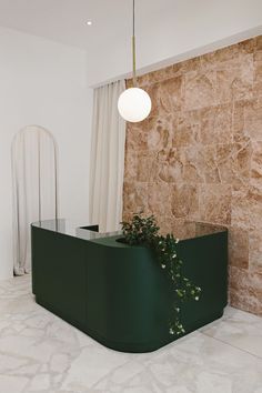 a green planter in the corner of a room