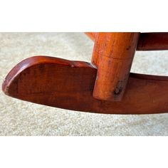 an old wooden rocking chair on carpeted floor